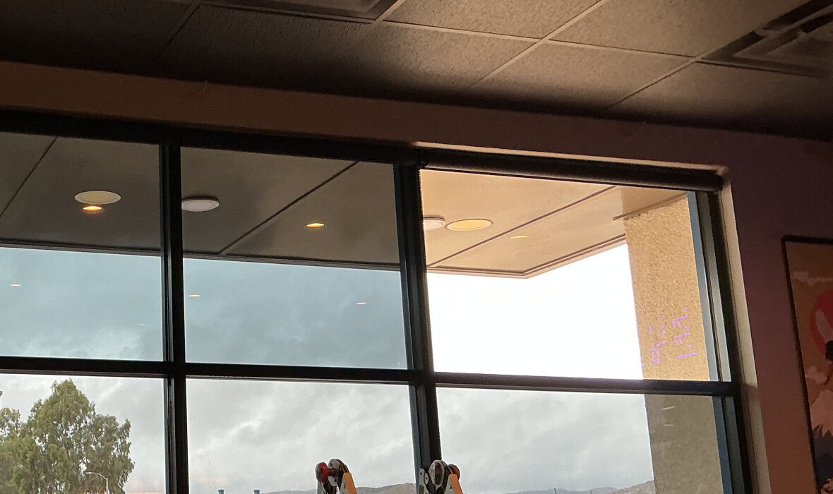 Upper storefront window detail from inside the restaurant after installation.