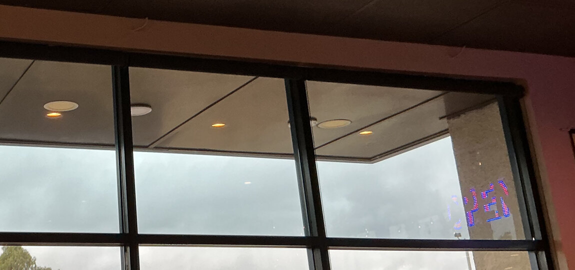 Upper restaurant storefront panes after window-film installation in Hemet.