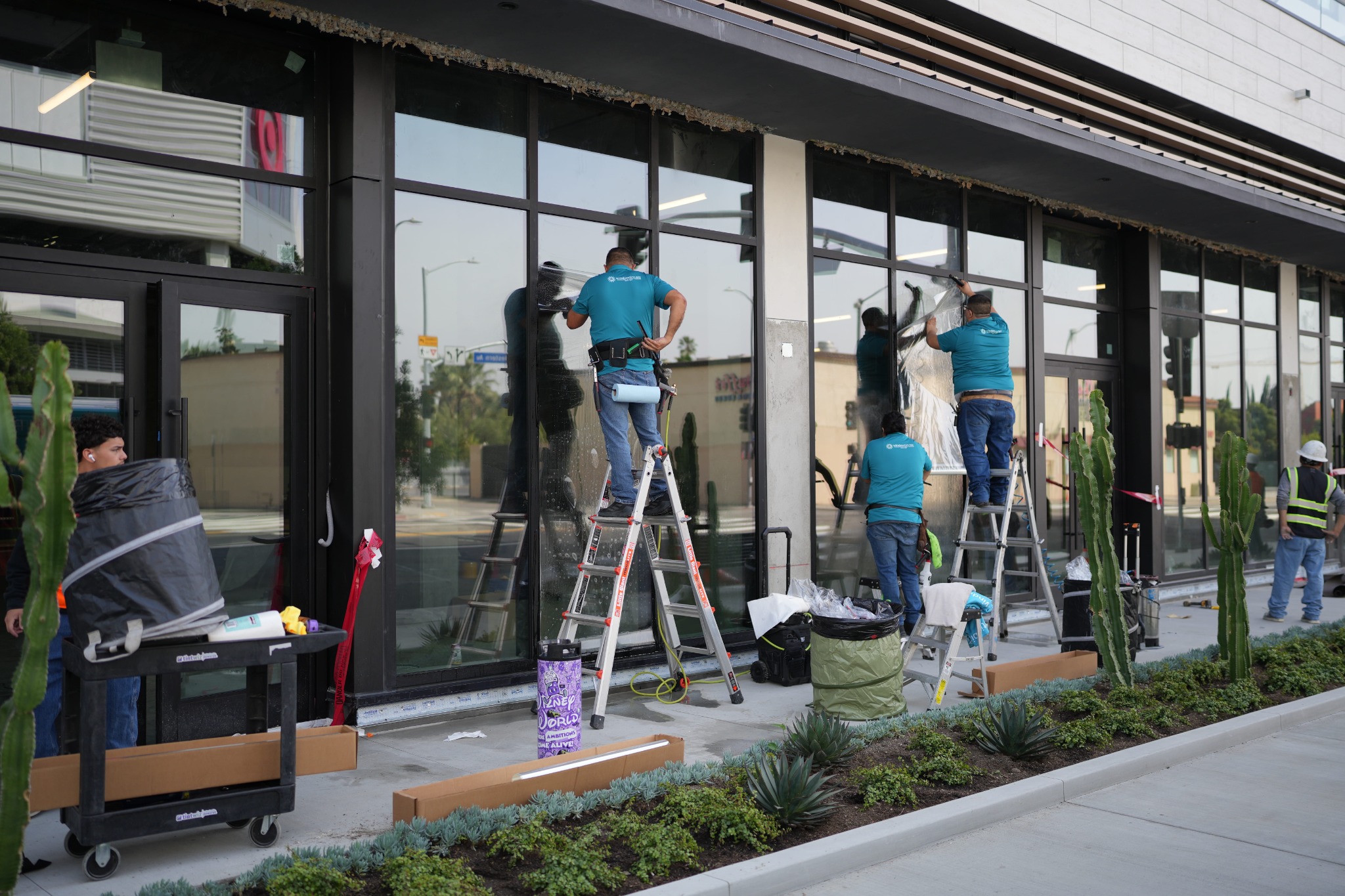 Installation team applying film to storefront windows