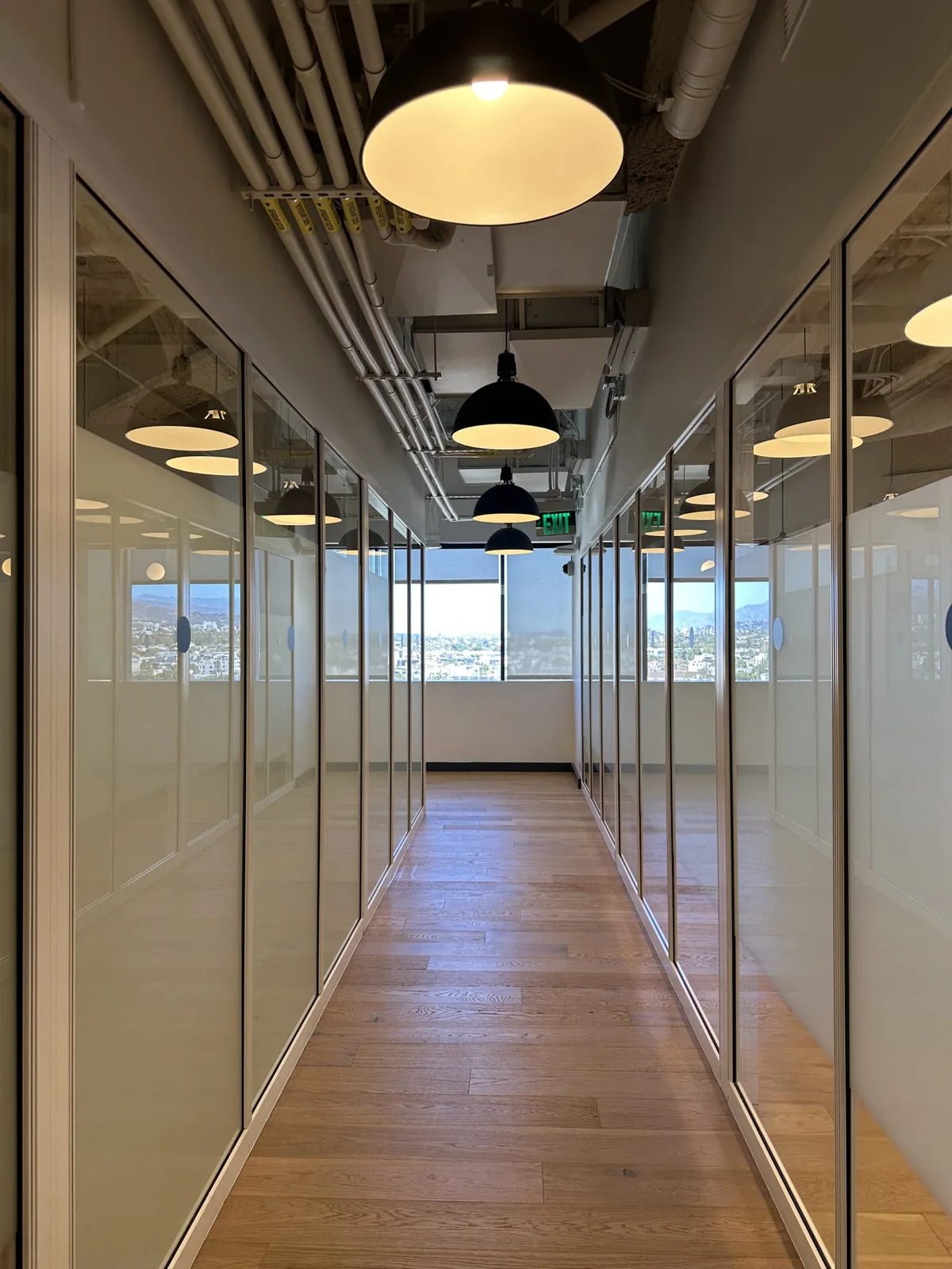 Office corridor with glass partitions and frosted panels