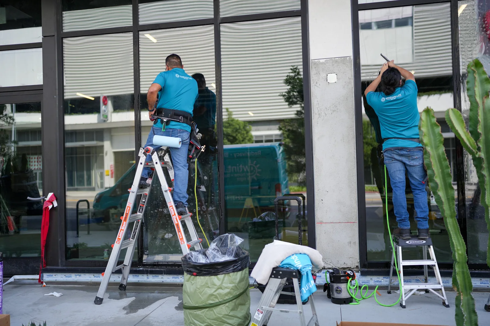 Two installers working on storefront glass